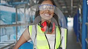 African american woman builder smiling confident holding hardhat at street