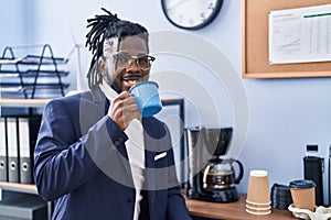 African american woman business worker drinking coffee at office