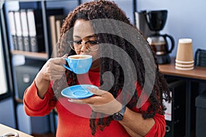 African american woman business worker drinking coffee at office