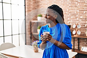 African american woman business worker smiling confident drinking coffee at home