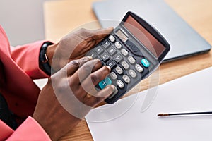 African american woman business worker using calculator at office