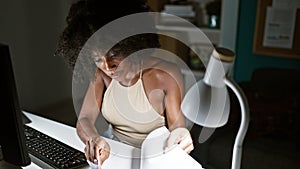 African american woman business worker using computer taking notes at the office