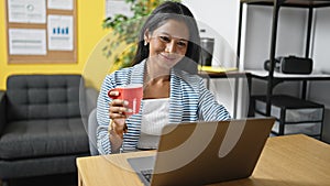 African american woman business worker using laptop drinking coffee at office