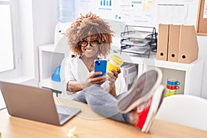 African american woman business worker using smartphone drinking coffee at office