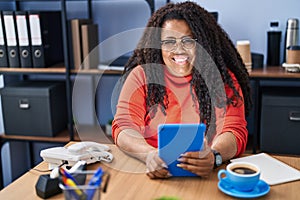 African american woman business worker using touchpad drinking coffee at office