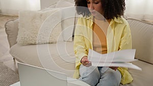 African American woman businesswoman interior designer working with financial graphs market research color palette guide