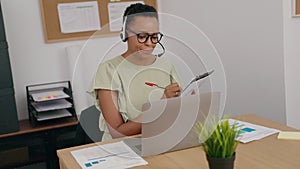 African american woman call center agent smiling confident working at office