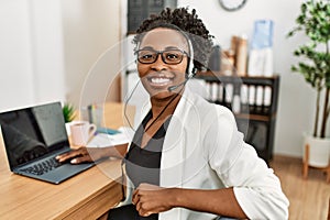 African american woman call center agent smiling confident working at office