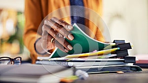 African american woman checking documents while working at creative office