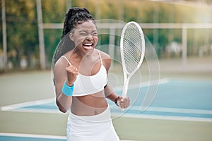 African american woman cheering after a tennis match. Young woman celebrating her success after a tennis match. Young