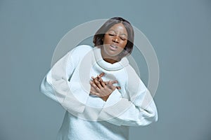 African american woman choking feeling pain ache touching chest suffer from heartache, shortness of breath, panic attack