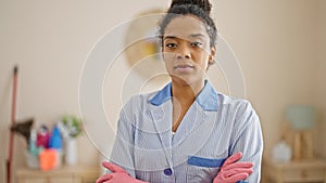 African american woman clean professional standing with arms crossed gesture smiling at hotel room