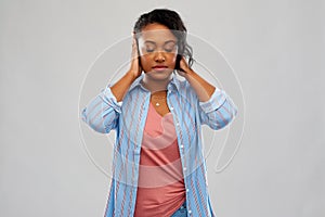 African american woman closing ears by hands