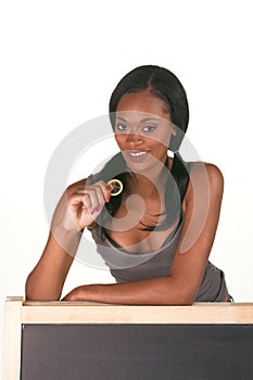 African-American woman with condom by blackboard