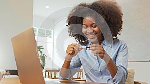 African American woman in curly hair with positive result of pregnancy test