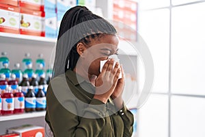African american woman customer using napkin at pharmacy