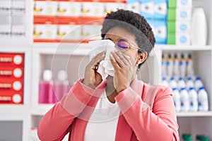 African american woman customer using napkin at pharmacy