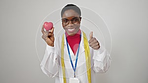 African american woman dietician doing thumb up holding heart over isolated white background