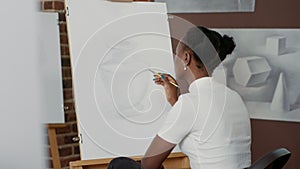 African american woman drawing professional sketch on canvas