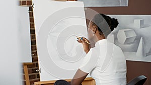 African american woman drawing professional sketch on canvas