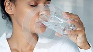 African American woman drink water from glass