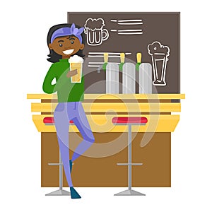 African-american woman drinking beer at the bar.