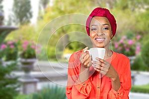 African american woman drinking tea from cup or mug