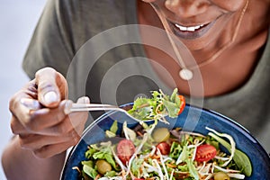 African american woman eating fresh healthy salad