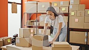 African american woman ecommerce business worker using laptop with serious face at office