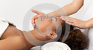 African-American Woman Enjoying Anti Aging Facial Massage