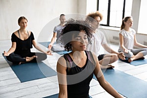 African American woman enjoying meditation, practicing yoga, Padmasana exercise