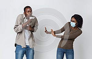 African american woman in face mask afraid of coughing woman