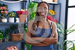 African american woman florist smiling confident standing with arms crossed gesture at flower shop