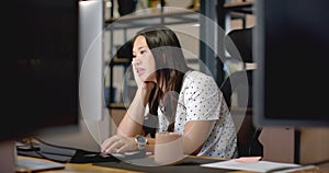 African American woman focuses on her laptop at the business office