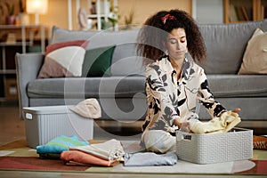 African American woman folding clothes