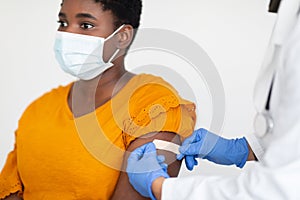 African American Woman Getting Vaccinated Against Covid-19, White Background, Cropped photo