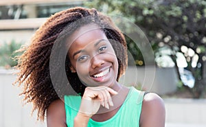 African american woman in a green shirt outdoor