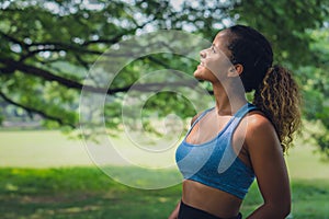 African american woman having fun work out in park in sportswear