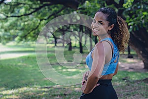 African american woman having fun work out in park in sportswear