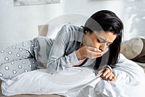 African american woman having toxicosis vomit in apartment photo