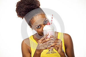 African American woman hides behind milkshake