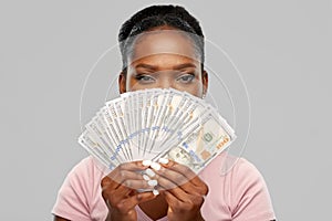 African american woman hiding behind dollar money