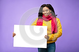 African American Woman Holding Blank Board Posing Over Purple Background