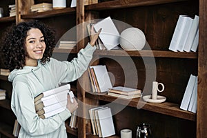 African american woman holding books in hands