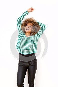 African american woman laughing with arms raised