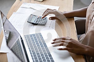 African American woman manage budget on computer