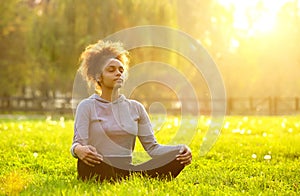 African american woman meditating in nature