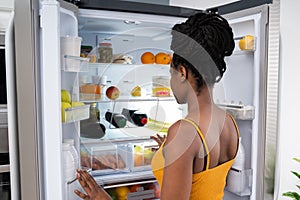 African American Woman Near Open Refrigerator