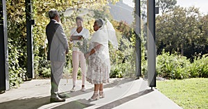 African american woman officiating wedding ceremony of senior biracial couple in garden, slow motion