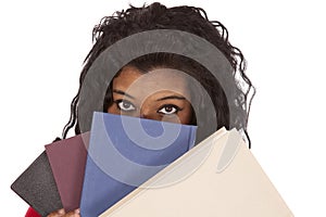 African American woman peaking from behind books photo